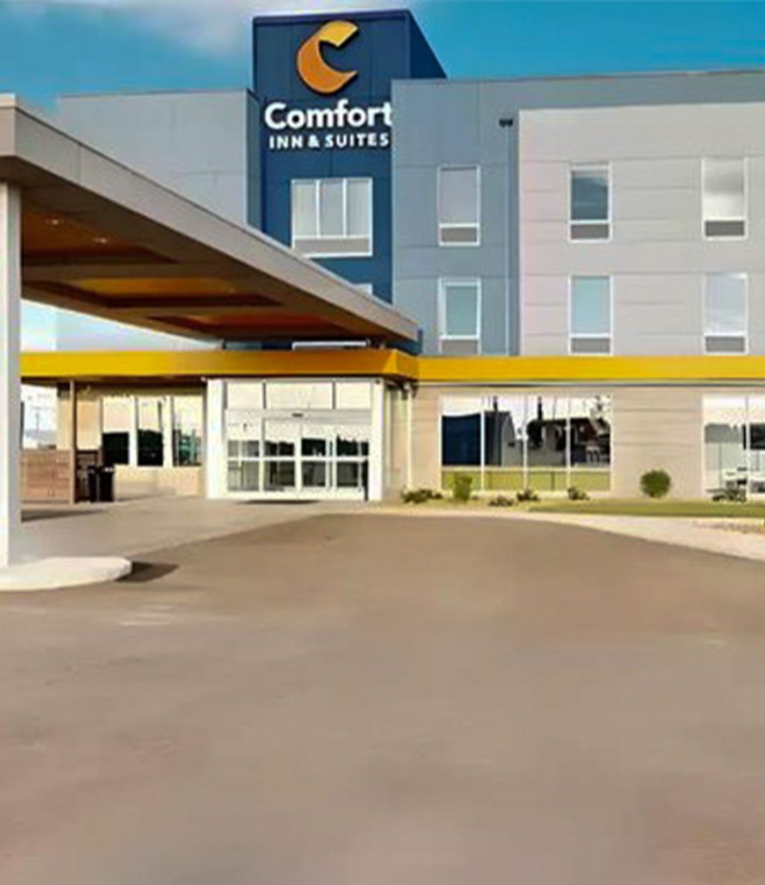 Comfort Inn & Suites hotel featuring a blue and yellow accent tower, modern design, and a covered drop-off entrance.